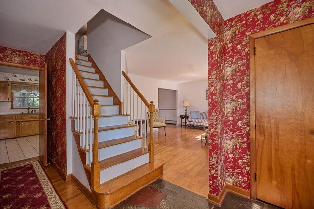 152 Bart Dr, Poughkeepsie, NY 12603 - staircase with wallpapered walls and wood finished floors