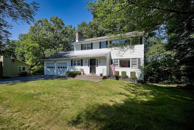 152 Bart Dr, Poughkeepsie, NY 12603 - view of front facade featuring a garage, driveway, a chimney, and a front yard
