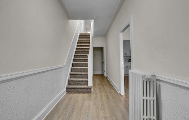 58-60 78th Ave, Glendale, NY 11385 - stairs featuring radiator heating unit and wood finished floors