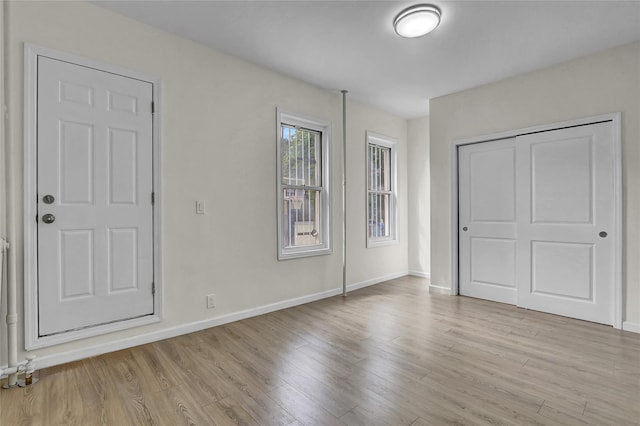 58-60 78th Ave, Glendale, NY 11385 - unfurnished bedroom featuring light wood-type flooring and a closet