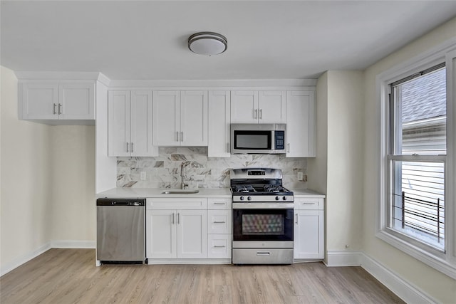 58-60 78th Ave, Glendale, NY 11385 - kitchen featuring appliances with stainless steel finishes, light wood-type flooring, and light countertops