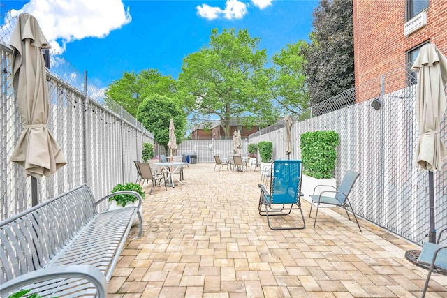 209-10 41st Ave Unit 2J, Bayside, NY 11361 - fenced backyard with outdoor dining space and a patio