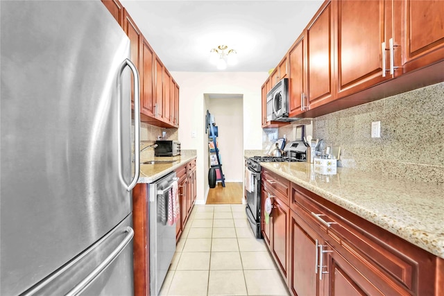 209-10 41st Ave Unit 2J, Bayside, NY 11361 - kitchen featuring stainless steel appliances, tasteful backsplash, light tile patterned floors, and light stone counters