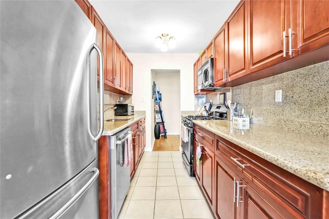 209-10 41st Ave Unit 2J, Bayside, NY 11361 - kitchen with stainless steel appliances, decorative backsplash, light tile patterned floors, and light stone counters