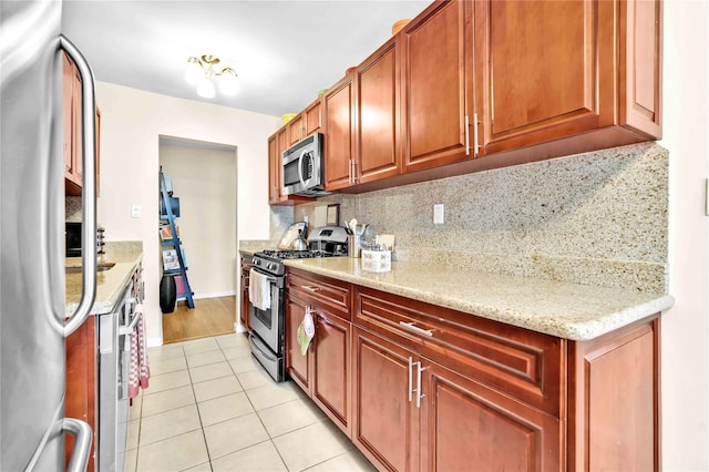 209-10 41st Ave Unit 2J, Bayside, NY 11361 - kitchen with appliances with stainless steel finishes, light tile patterned flooring, decorative backsplash, and light stone countertops
