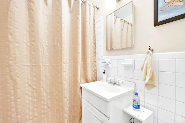 209-10 41st Ave Unit 2J, Bayside, NY 11361 - full bathroom with tile walls, vanity, a shower with shower curtain, and wainscoting