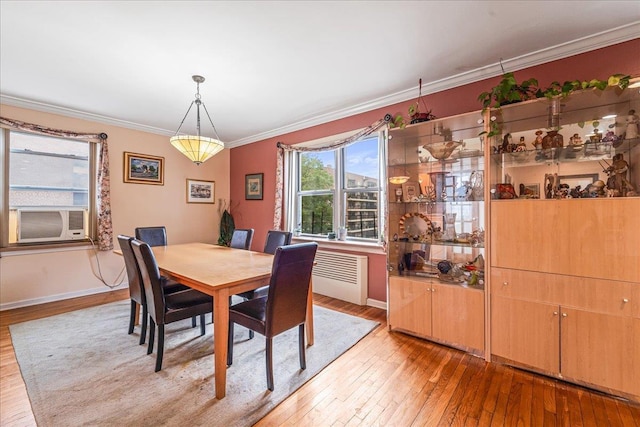 162-41 Powells Cove Blvd Unit 4D, Beechhurst, NY 11357 - dining room with light wood-style flooring, crown molding, cooling unit, and radiator heating unit