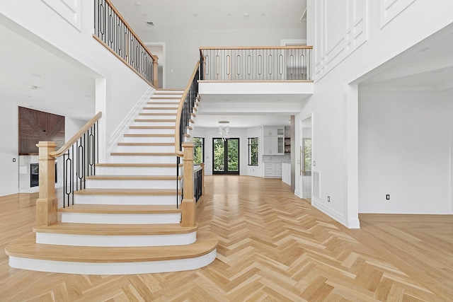 26 Saint Andrews Ct, Old Westbury, NY 11568 - stairway featuring a towering ceiling
