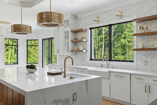 26 Saint Andrews Ct, Old Westbury, NY 11568 - kitchen with open shelves, healthy amount of natural light, tasteful backsplash, and crown molding