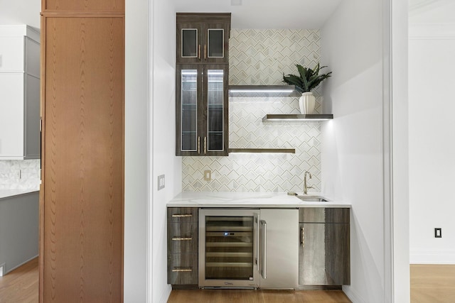 26 Saint Andrews Ct, Old Westbury, NY 11568 - indoor wet bar with beverage cooler, tasteful backsplash, and light wood-style flooring