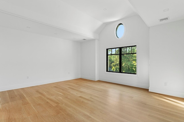 26 Saint Andrews Ct, Old Westbury, NY 11568 - empty room with lofted ceiling and light wood-type flooring
