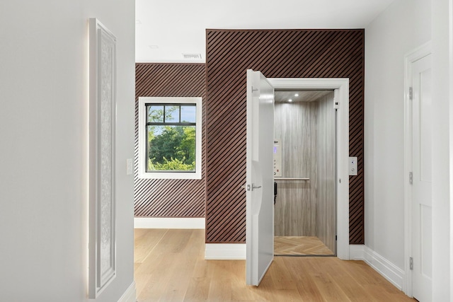 26 Saint Andrews Ct, Old Westbury, NY 11568 - hallway with wood finished floors and an accent wall