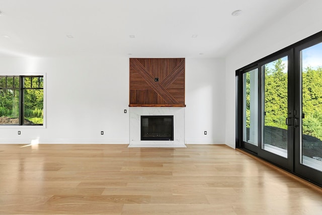 26 Saint Andrews Ct, Old Westbury, NY 11568 - unfurnished living room featuring light wood-style floors and a fireplace