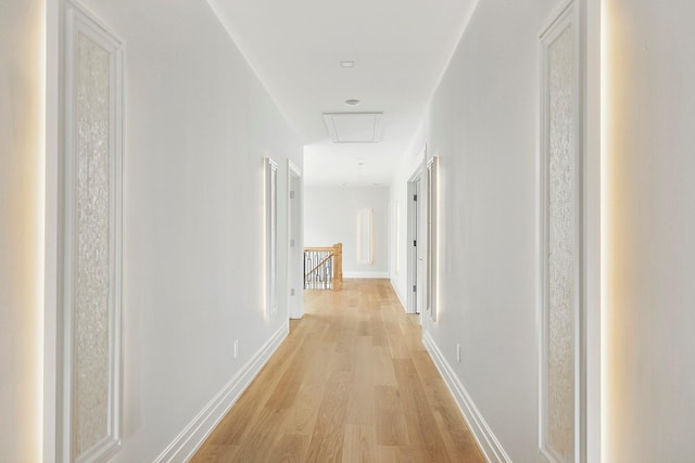 26 Saint Andrews Ct, Old Westbury, NY 11568 - hallway with an upstairs landing, light wood-style floors, and attic access