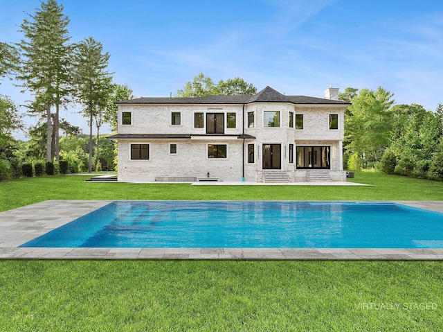 26 Saint Andrews Ct, Old Westbury, NY 11568 - rear view of house with a patio, a chimney, a yard, and an outdoor pool