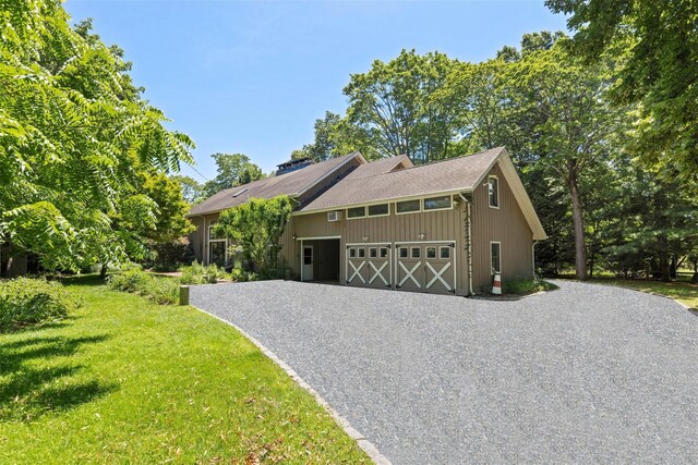 880 W Mill Rd, Mattituck, NY 11952 - view of front of home with driveway, a front yard, and a garage