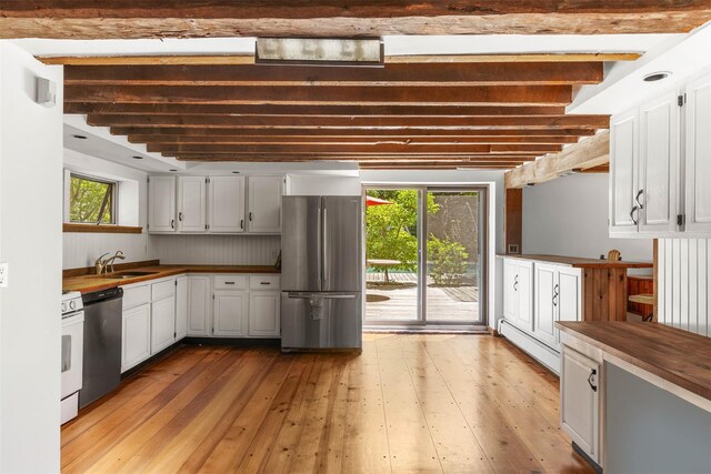 880 W Mill Rd, Mattituck, NY 11952 - kitchen with stainless steel appliances, wooden counters, light wood-type flooring, beamed ceiling, and plenty of natural light