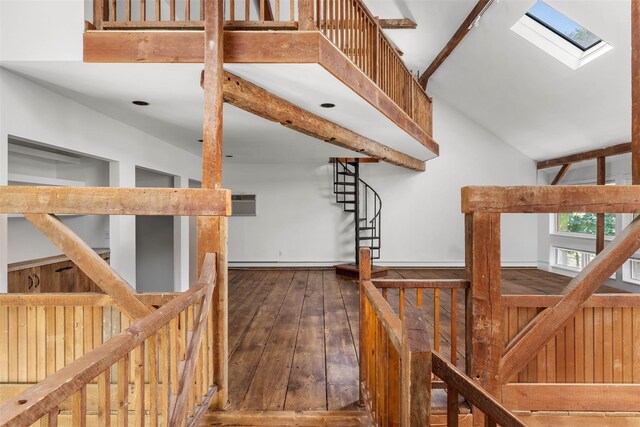 880 W Mill Rd, Mattituck, NY 11952 - stairs featuring a skylight, hardwood / wood-style flooring, a wall mounted air conditioner, a baseboard heating unit, and vaulted ceiling