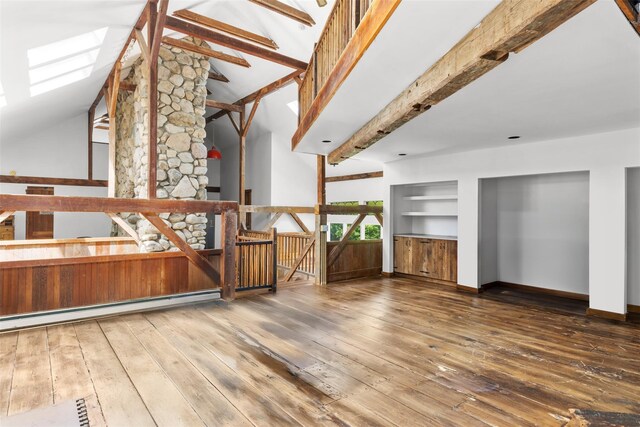880 W Mill Rd, Mattituck, NY 11952 - unfurnished living room with hardwood / wood-style flooring, a baseboard heating unit, and a skylight