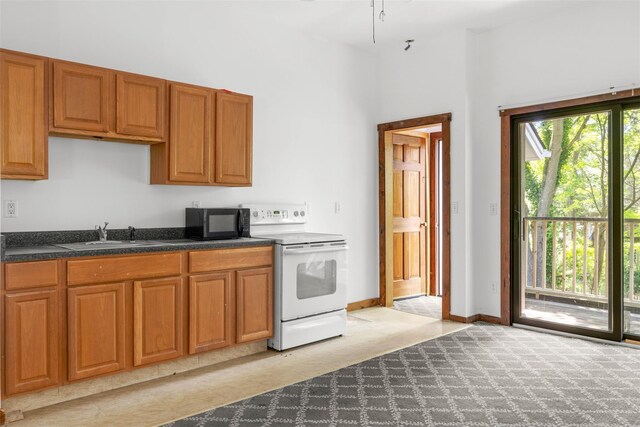 880 W Mill Rd, Mattituck, NY 11952 - kitchen with electric stove, black microwave, light colored carpet, brown cabinetry, and dark countertops