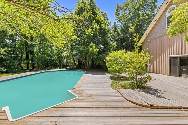 880 W Mill Rd, Mattituck, NY 11952 - swimming pool with a deck and view of wooded area