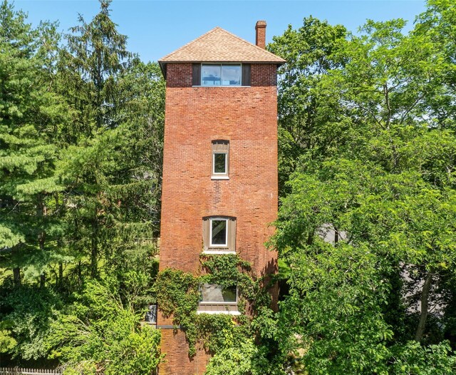 880 W Mill Rd, Mattituck, NY 11952 - view of side of property with brick siding and a chimney
