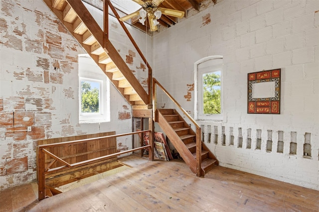880 W Mill Rd, Mattituck, NY 11952 - stairs with a high ceiling, healthy amount of natural light, a ceiling fan, and hardwood / wood-style floors