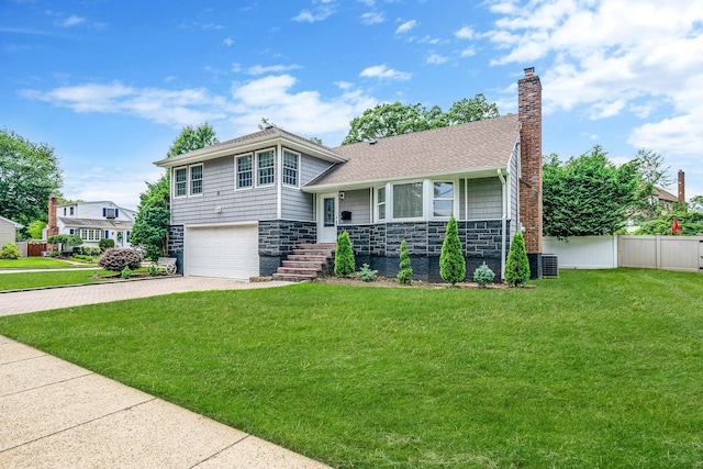 5 Pickett Ct, Malverne, NY 11565 - tri-level home with driveway, stone siding, a garage, and a chimney