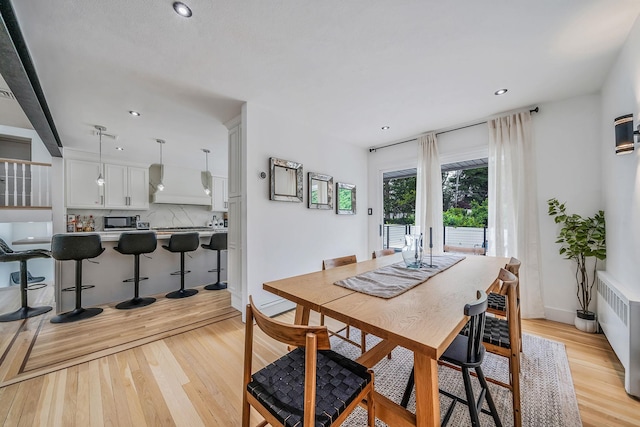 5 Pickett Ct, Malverne, NY 11565 - dining space featuring light wood finished floors, radiator, and recessed lighting