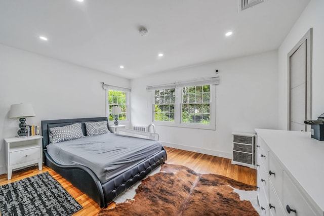 5 Pickett Ct, Malverne, NY 11565 - bedroom with light wood-style floors, recessed lighting, and wine cooler