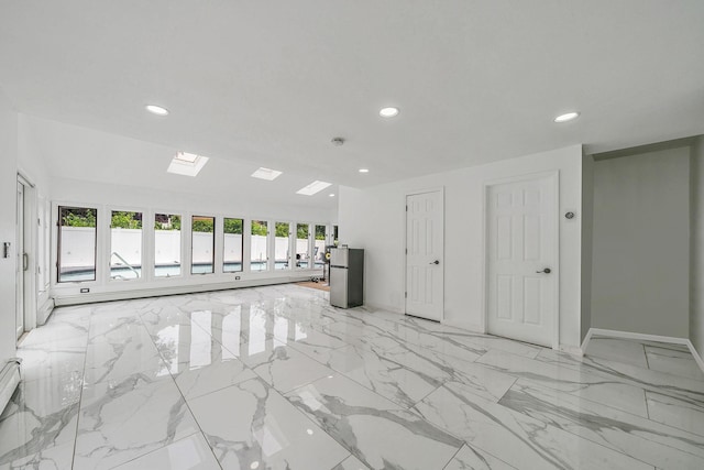 5 Pickett Ct, Malverne, NY 11565 - unfurnished living room with recessed lighting, a skylight, and light marble finish floors
