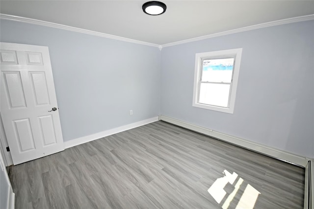 67 Maplewood Dr, Westbury, NY 11590 - unfurnished room with ornamental molding, a baseboard radiator, and wood finished floors