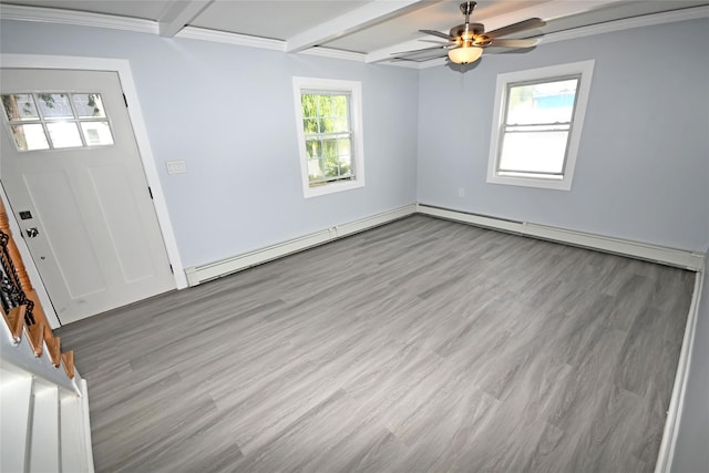 67 Maplewood Dr, Westbury, NY 11590 - entrance foyer featuring wood finished floors, beamed ceiling, plenty of natural light, a ceiling fan, and ornamental molding