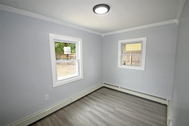 67 Maplewood Dr, Westbury, NY 11590 - spare room with ornamental molding, a baseboard heating unit, wood finished floors, and baseboard heating