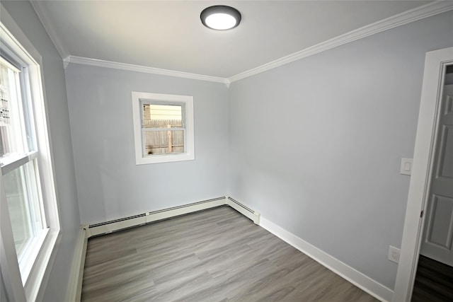 67 Maplewood Dr, Westbury, NY 11590 - unfurnished room featuring ornamental molding, wood finished floors, and a baseboard heating unit