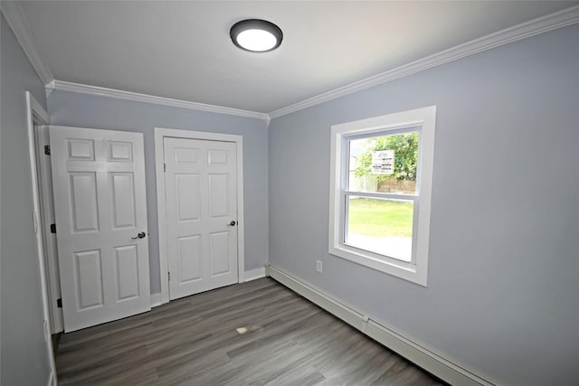 67 Maplewood Dr, Westbury, NY 11590 - unfurnished bedroom featuring a baseboard heating unit, crown molding, and wood finished floors