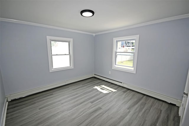 67 Maplewood Dr, Westbury, NY 11590 - spare room featuring ornamental molding, baseboard heating, and wood finished floors