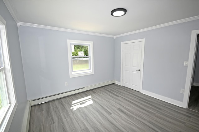 67 Maplewood Dr, Westbury, NY 11590 - unfurnished room with a baseboard heating unit, crown molding, and wood finished floors