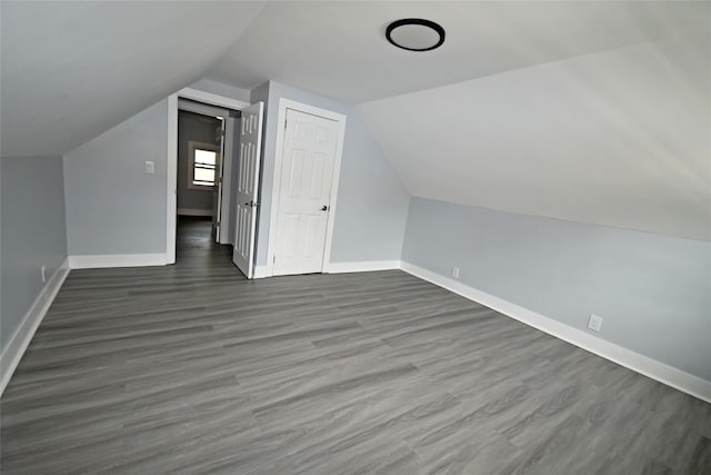67 Maplewood Dr, Westbury, NY 11590 - additional living space featuring lofted ceiling and dark wood-style flooring