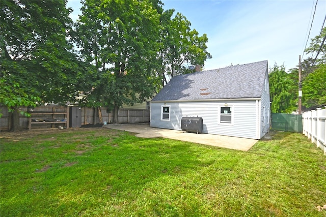 67 Maplewood Dr, Westbury, NY 11590 - back of house with a patio area, heating fuel, a fenced backyard, and roof with shingles