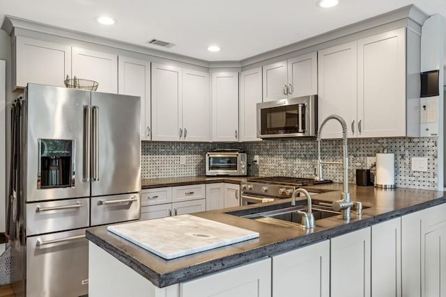 11065 Old Sound Ave, Mattituck, NY 11952 - kitchen featuring stainless steel appliances, a peninsula, tasteful backsplash, and recessed lighting