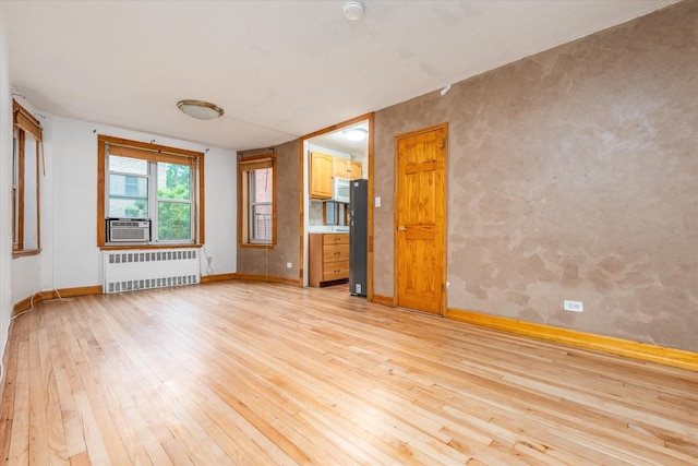 33-35 81st St Unit 4A, Jackson Heights, NY 11372 - spare room featuring radiator heating unit, light wood finished floors, and cooling unit
