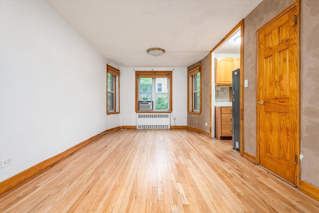33-35 81st St Unit 4A, Jackson Heights, NY 11372 - unfurnished room featuring radiator, light wood-style flooring, and cooling unit
