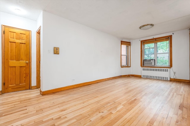 33-35 81st St Unit 4A, Jackson Heights, NY 11372 - unfurnished room with radiator, light wood finished floors, and cooling unit