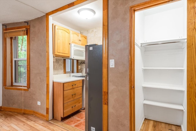 33-35 81st St Unit 4A, Jackson Heights, NY 11372 - kitchen featuring white appliances, light wood-type flooring, and light countertops