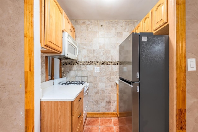 33-35 81st St Unit 4A, Jackson Heights, NY 11372 - kitchen with white appliances, light countertops, light tile patterned floors, tile walls, and light brown cabinets