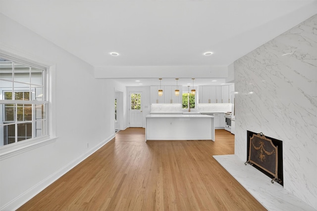 15 Benedict Ave, Eastchester, NY 10709 - unfurnished living room with light wood-type flooring, recessed lighting, and a fireplace