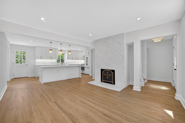 15 Benedict Ave, Eastchester, NY 10709 - unfurnished living room with light wood-style flooring, recessed lighting, and a premium fireplace