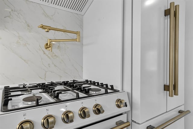 15 Benedict Ave, Eastchester, NY 10709 - kitchen view of white gas range oven, pot filler, high end fridge, light stone countertops, and backsplash