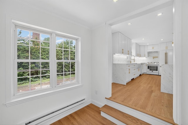 15 Benedict Ave, Eastchester, NY 10709 - kitchen with white electric range oven, a baseboard heating unit, plenty of natural light, light wood-style floors, and crown molding